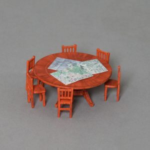 A large round table with 6 chairs and 3 x maps
