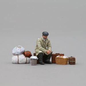 a male refugee sits with his suitcases and other household effects and wonders what has become of his world