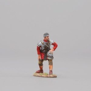 a standing Legionnaire with helmet removed and strapped to his belt stands by ready to spring into action