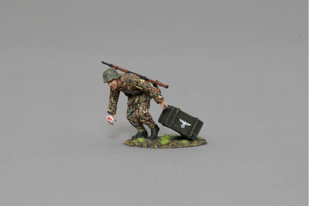 An SS soldier hurriedly brings up ammunition for his comrades